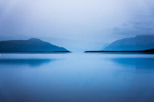landscape view of blue mountains over a lake