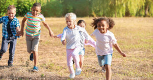 five children playing in a field